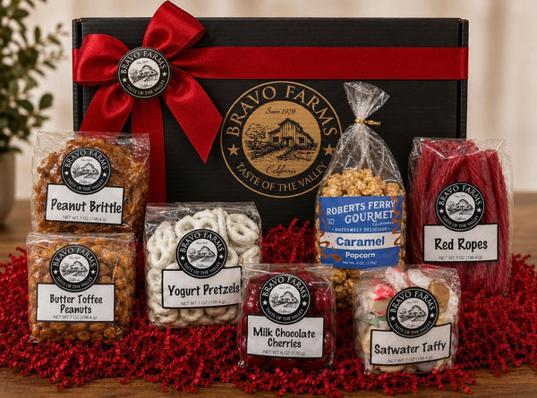 Tower of Treats Box with peanut brittle, butter toffee peanuts, yogurt pretzels, milk chocolate cherries, caramel popcorn, red ropes and salt water taffy