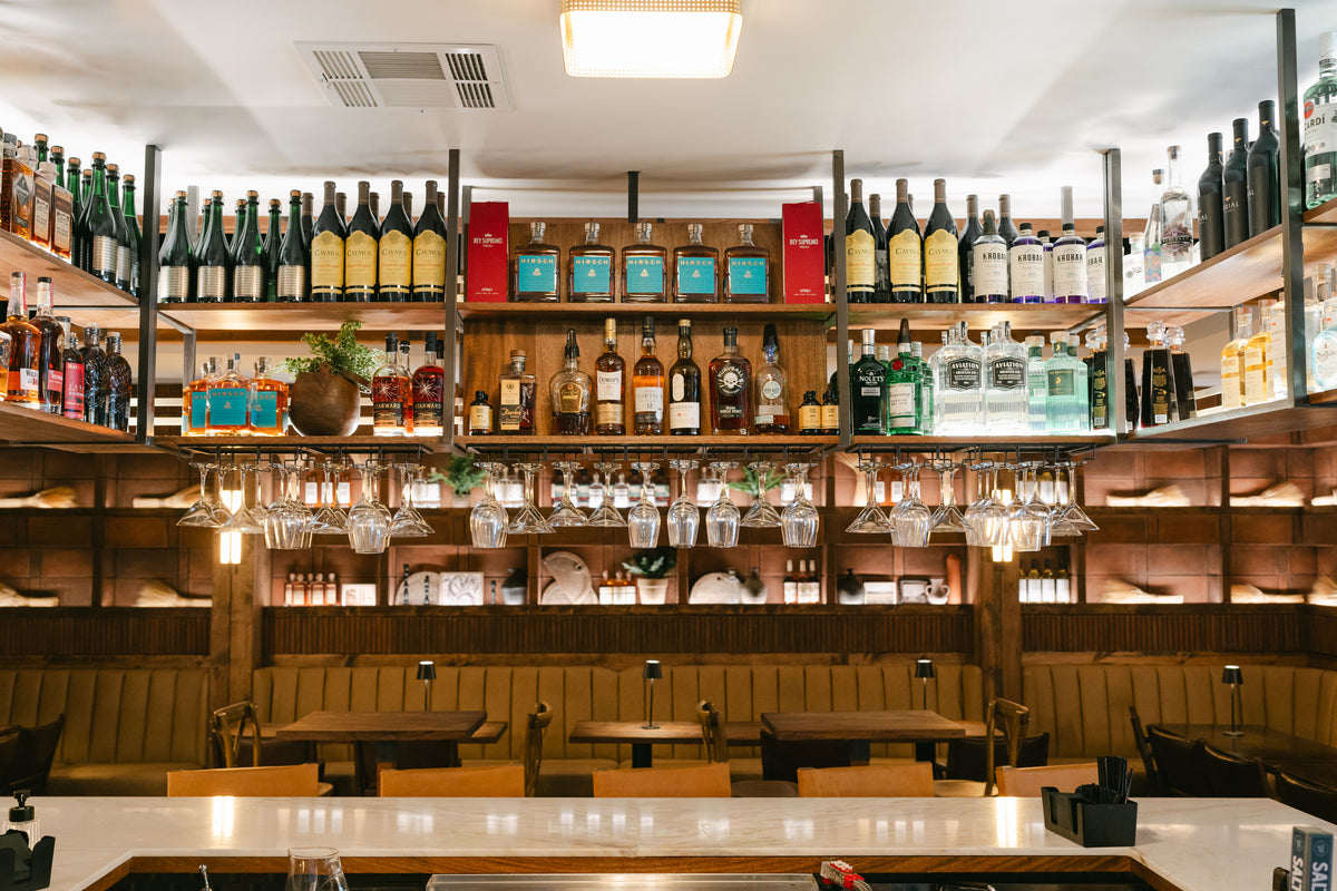 Shelves of wine and spirits behind the bar at Bravo Farms in Visalia